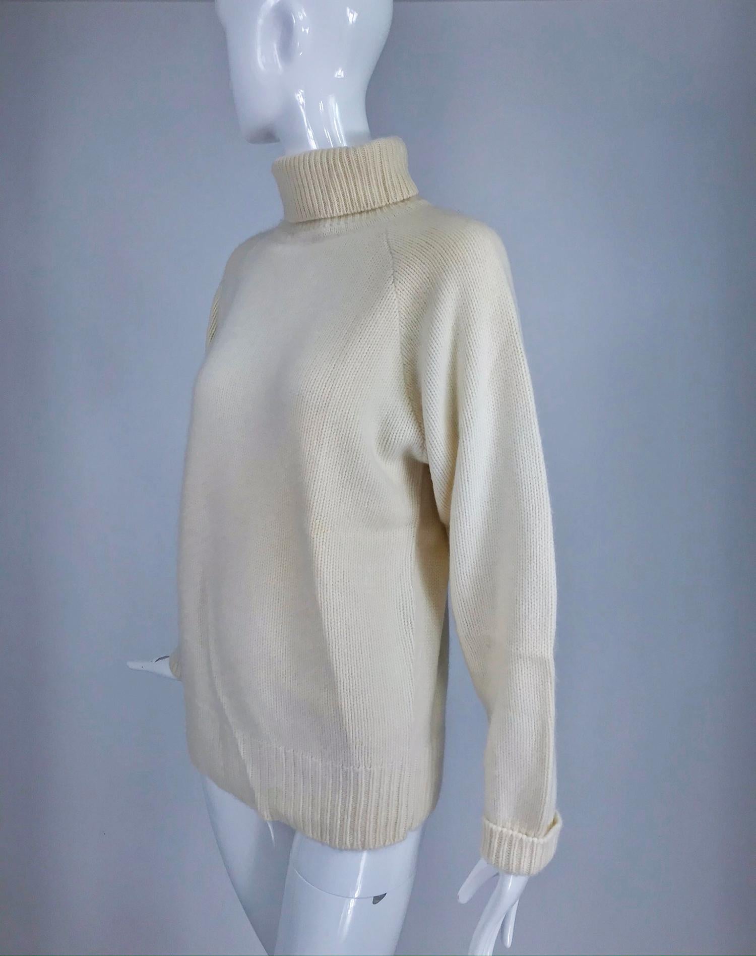 Zoran off white chunky cashmere turtleneck sweater from the 1990s. Pull on sweater with raglan sleeves. Neck, cuffs and hem of ribbed knit. This sweater has been packed away in cold storage for a while, the creases seen in the photos will fall out