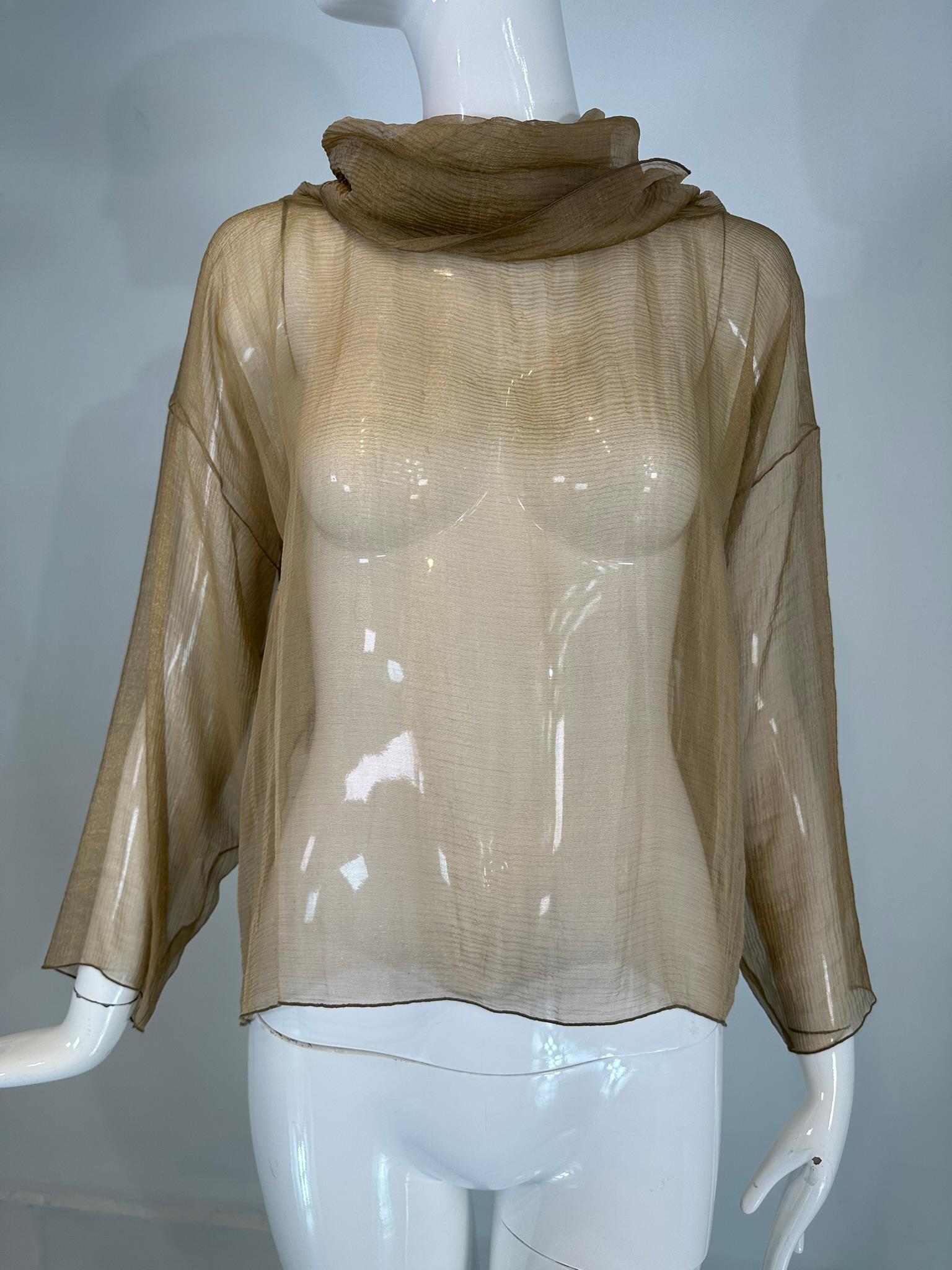 Zoran Vintage gold metallic sheer silk draped turtle neck long sleeve top.
Gorgeous shimmery sheer gold metallic silk draped turtle neck, long sleeve pull on top. Elegant simplicity was Zoran's craft & why women who love his clothing still seek his