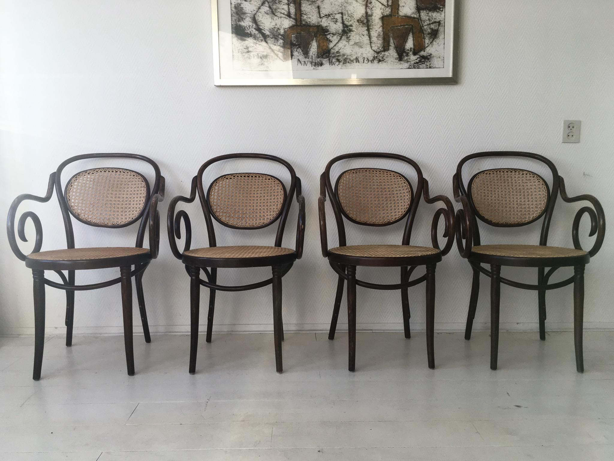 Stunning set of four bentwood and rattan chairs, which were manufactured by ZPM Radomsko (former factory of Thonet). They were manufactured in Polen with the same Thonet machines. The chairs are in Original, good condition with some wear consistent