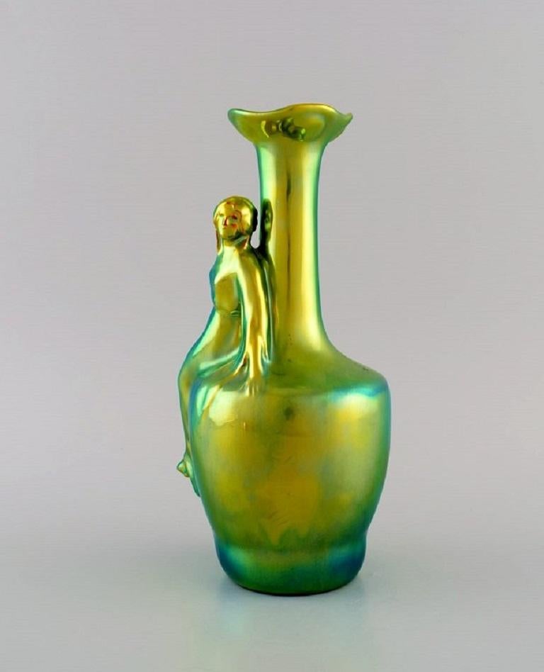 Zsolnay Art Nouveau vase in glazed ceramics modelled with a sitting woman. Beautiful eosin glaze. 20th Century.
Measures: 24 x 13 cm.
In excellent condition.
Stamped.