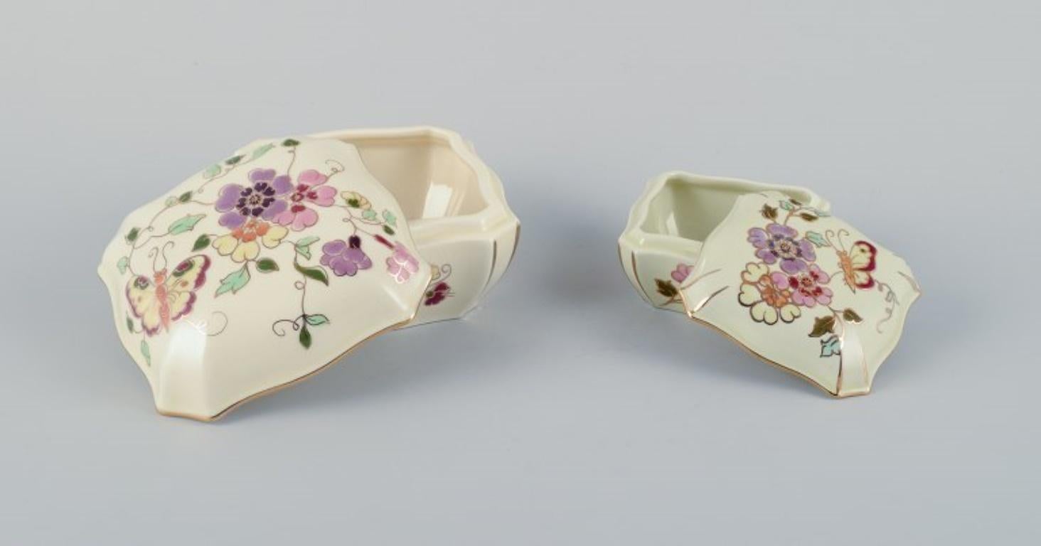 Hungarian Zsolnay, Hungary, two lidded jars in porcelain hand-painted with flower motifs. For Sale