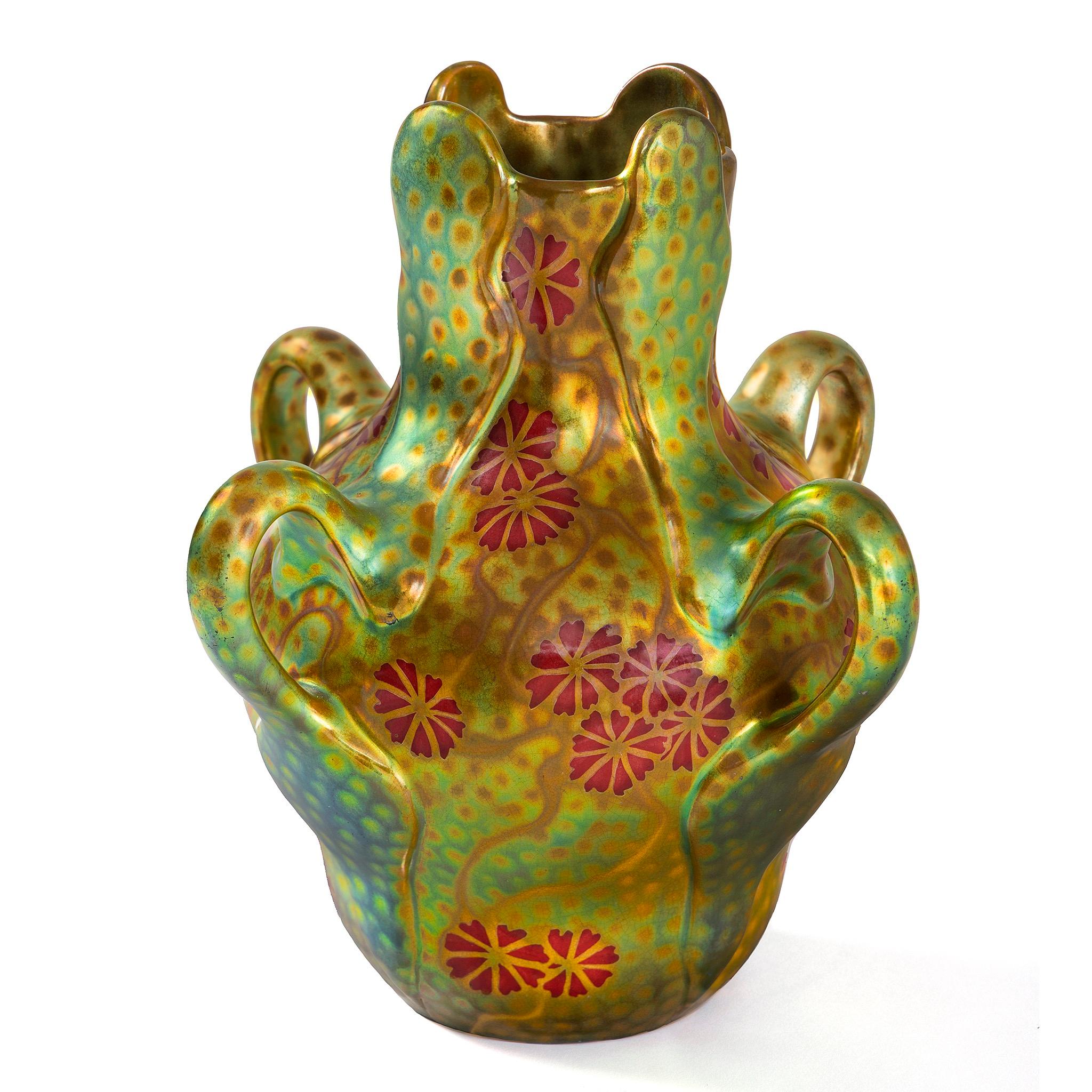 This evocative Japonist vase was designed by Sándor Apáti Abt for the Hungarian ceramic factory Zsolnay. The vase features a radiant background of gold, green, and orange, and is adorned with Japanese cosmos flowers, known as “秋桜” (akizakura).