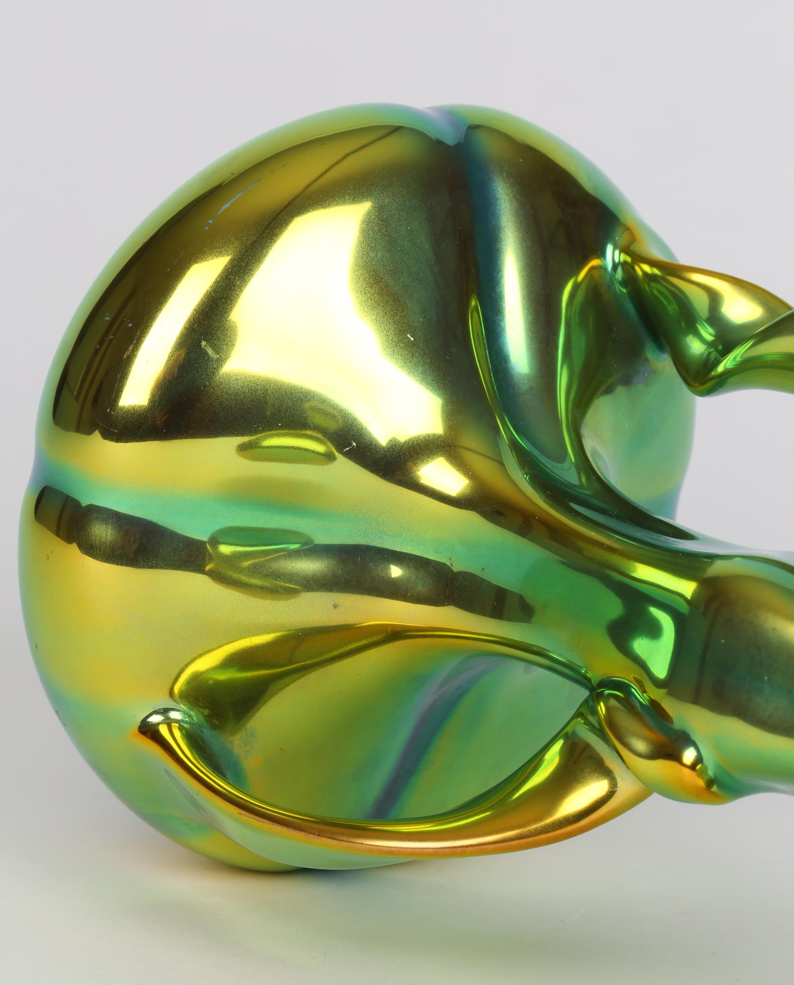 Stunning Hungarian Art Nouveau ribbon handled art pottery vase decorated in Eosin lustre glazes dating from around 1910. This striking vase has a squat wide rounded body standing on a narrow round foot with a slender shaped neck and with a wide
