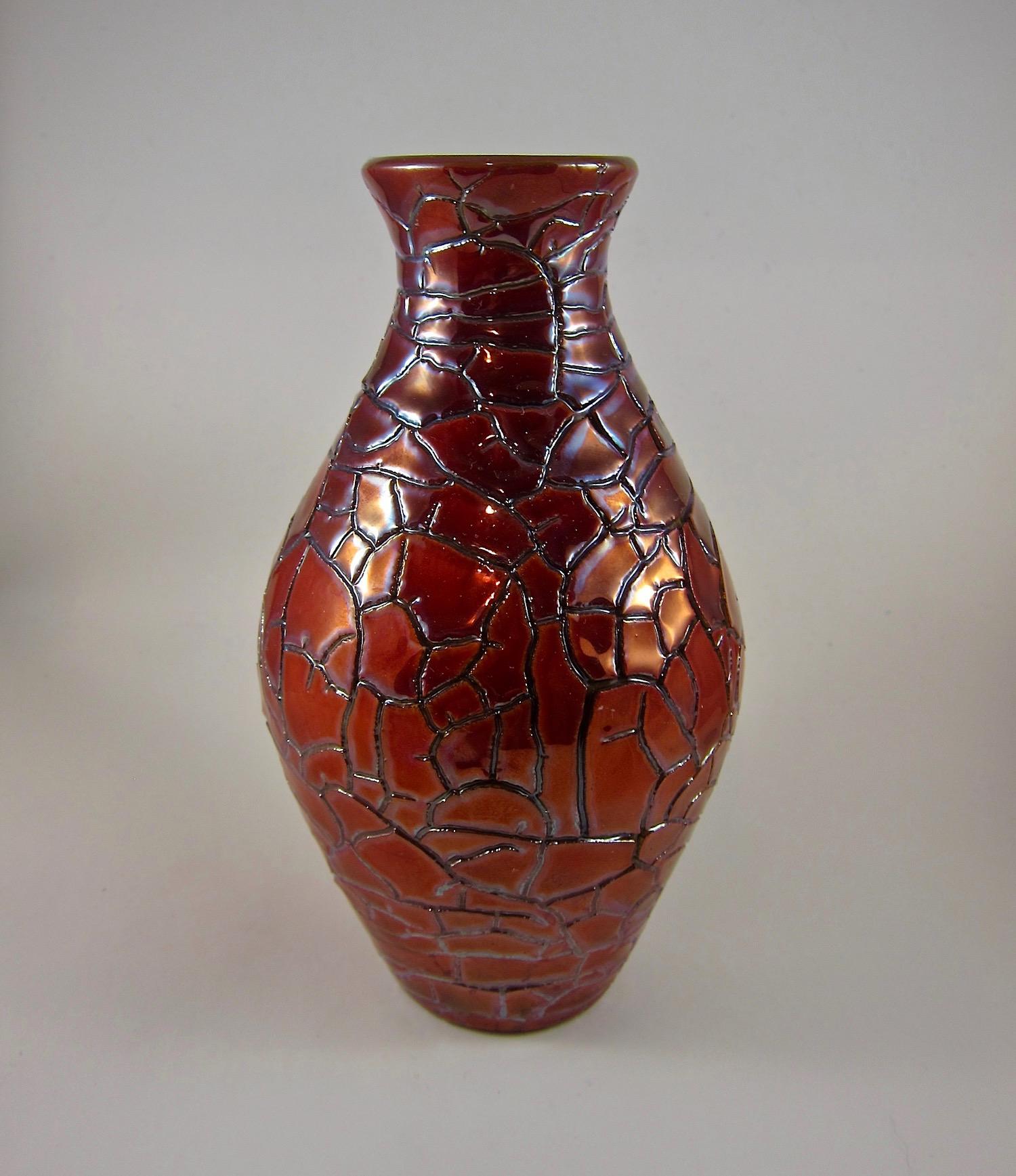 An Art Deco style porcelain faience posy vase produced in Hungary by Zsolnay of Pecs and dating to the late 1950s - early 1960s. This vintage vessel is decorated with Zsolnay's signature eosin glaze in a rich and deep red. The glaze has a lively,