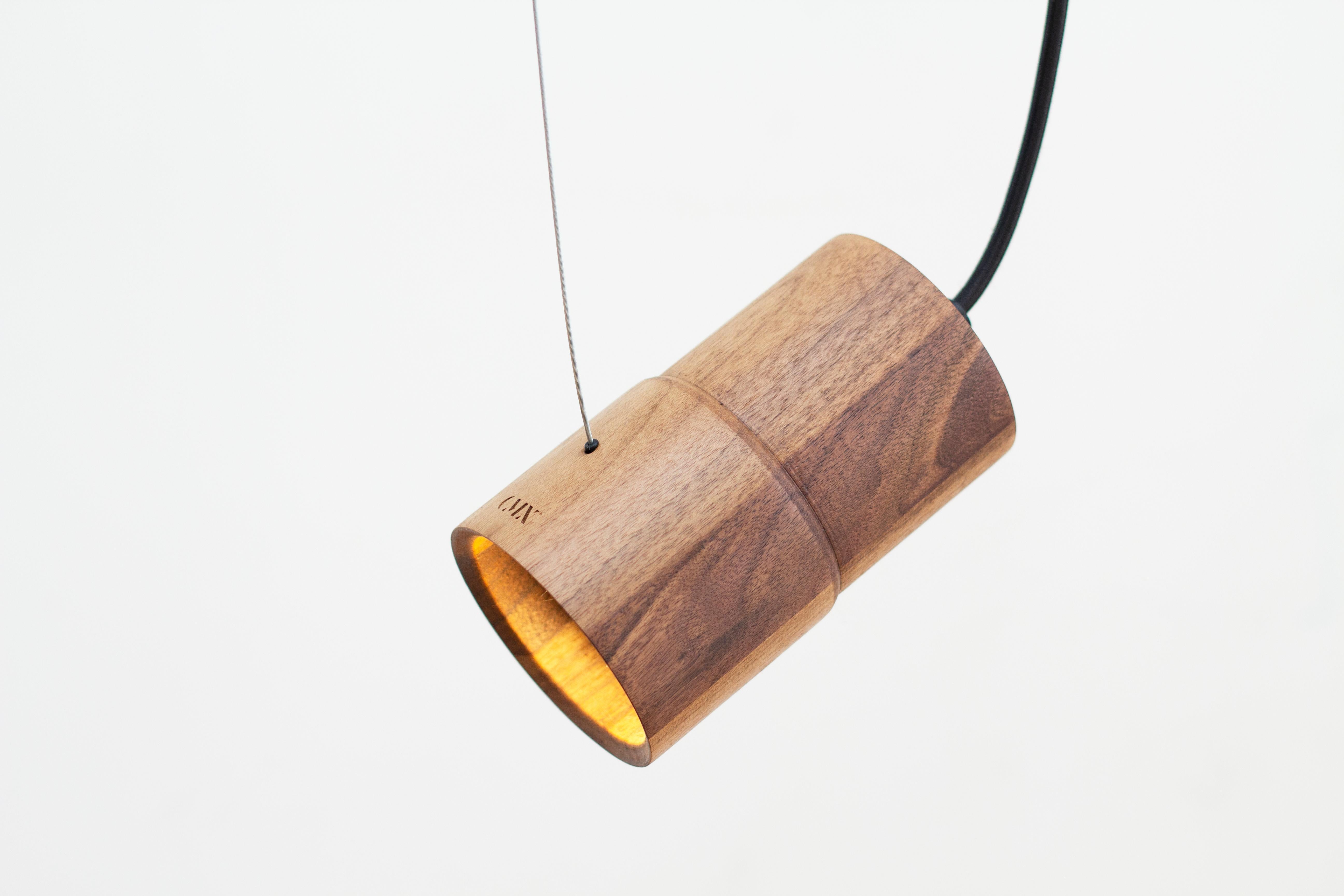 The ZUCC Pendant Lamp is carefully crafted from turned solid wood, highlighting the intrinsic natural beauty of the material. Its design embraces a natural aesthetic that adds warmth and sophistication to any indoor space.
