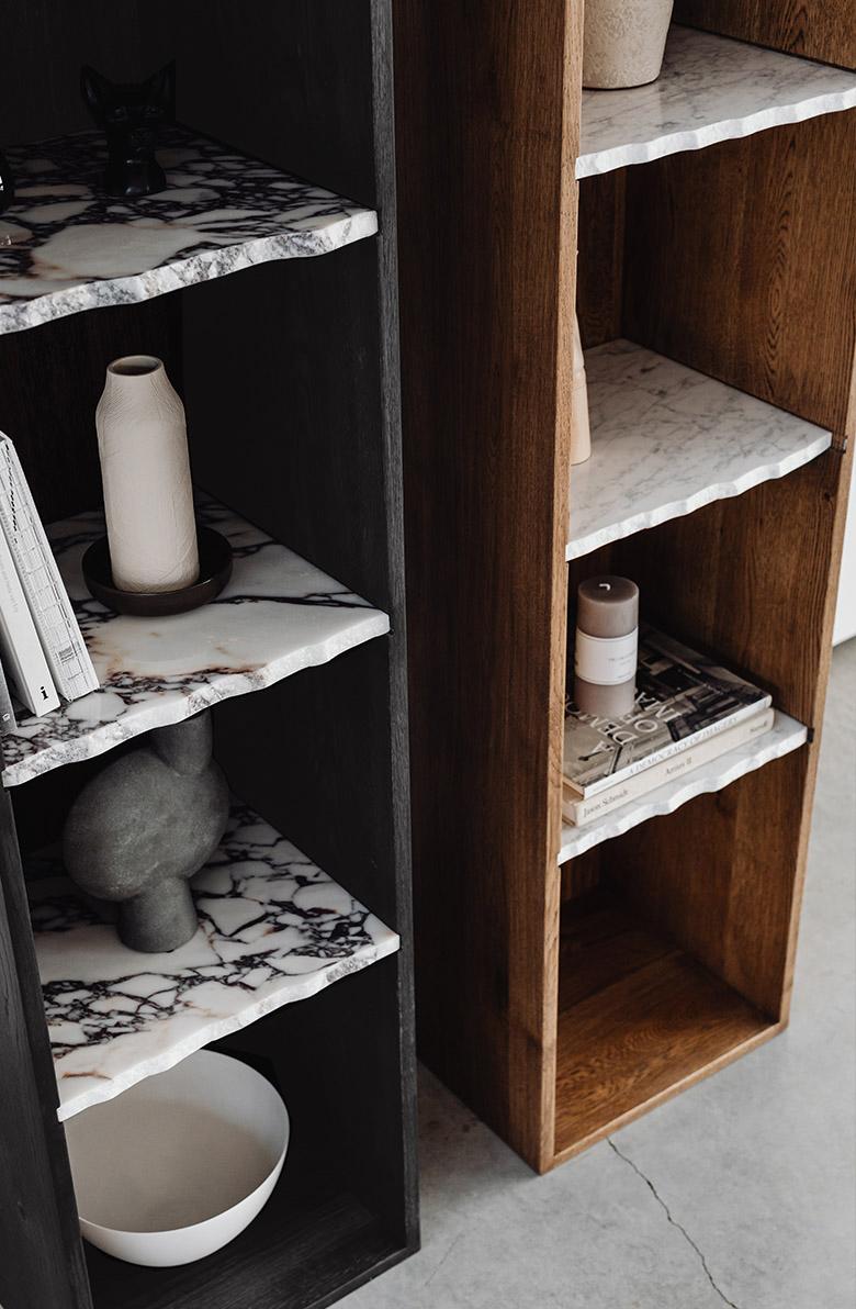 ZUEL is a piece of furniture where you can display your favourite albums, vases or photo frames. The body of the bookcase is made of solid wood. Its irregularly arranged, marble shelves with a beautiful, raw, slightly rough finish of the edges are