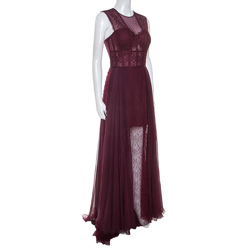 Sway like a dream in this evening gown from Zuhair Murad. Tailored to perfection, the grand burgundy gown brings the elegance of lace coupled with a feminine silhouette. It has a back zipper and a hemline that beautifully falls to the floor. Pair it
