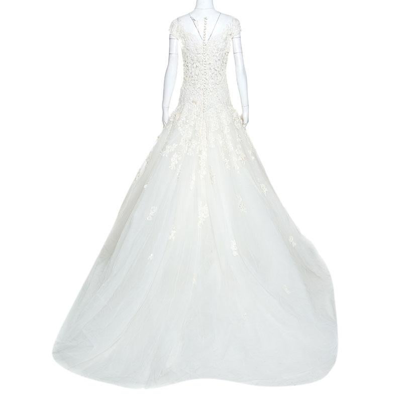 Zuhair Murad's signature touch of elegance is wonderfully employed in this wedding gown. It is an exquisite choice for brides-to-be. This masterpiece comes in a dreamy white design, featuring heavy embroidery beautifully receding down the skirt in a