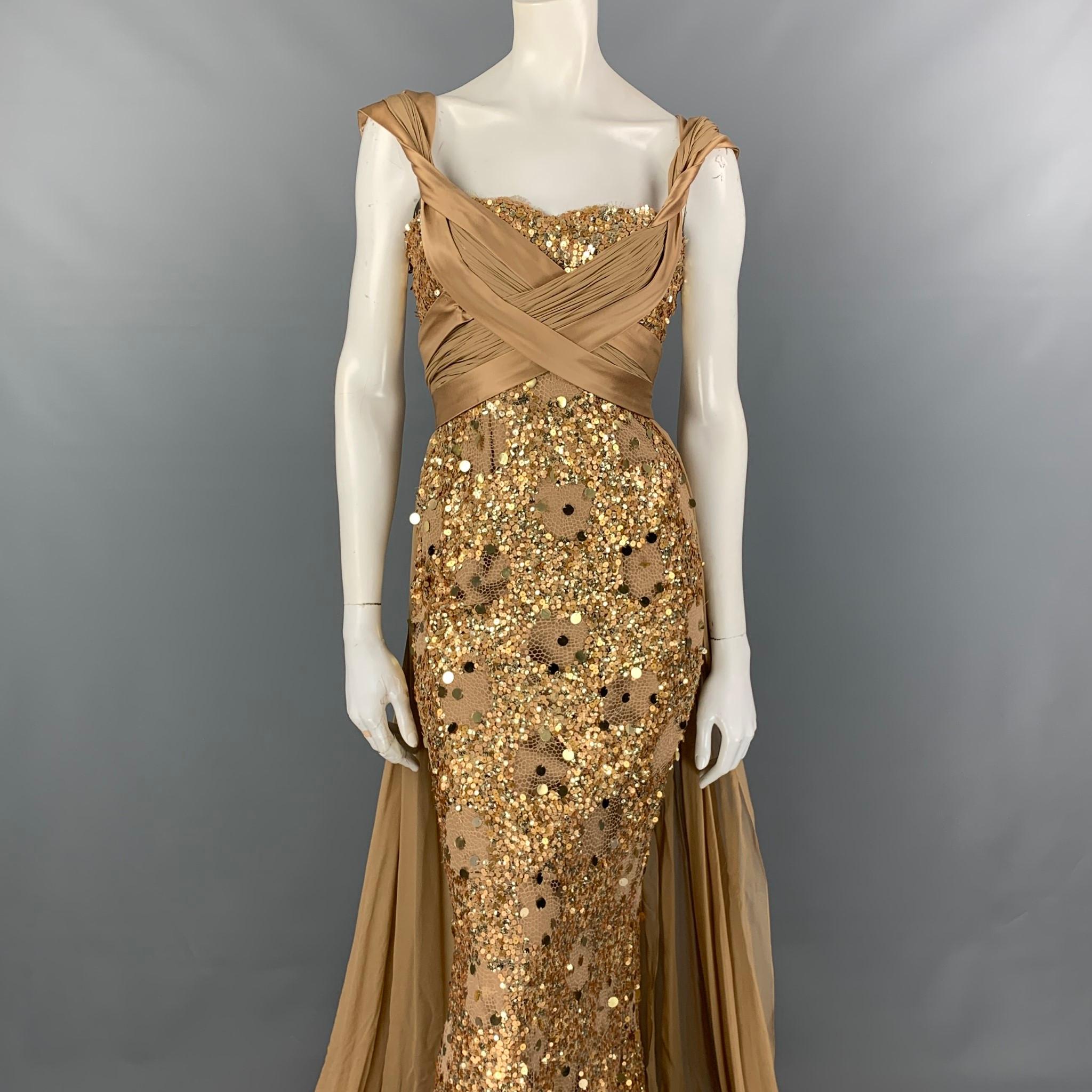 ZUHAIR MURAD gown comes in a beige & gold silk blend with a slip liner featuring a ruched bodice, sequined details, crossover straps, and a back zip up closure. 

Very Good Pre-Owned Condition.
Marked: 40

Measurements:

Bust: 30 in.
Waist: 24