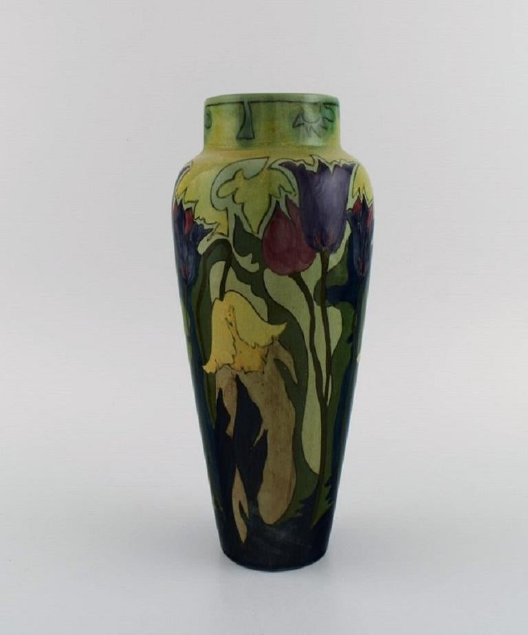 Zuid-Holland, Gouda. 
Antique Art Nouveau vase in glazed ceramics with hand-painted flowers and foliage. 
Approx. 1900.
Measures: 28 x 12.5 cm.
In excellent condition.
Stamped.