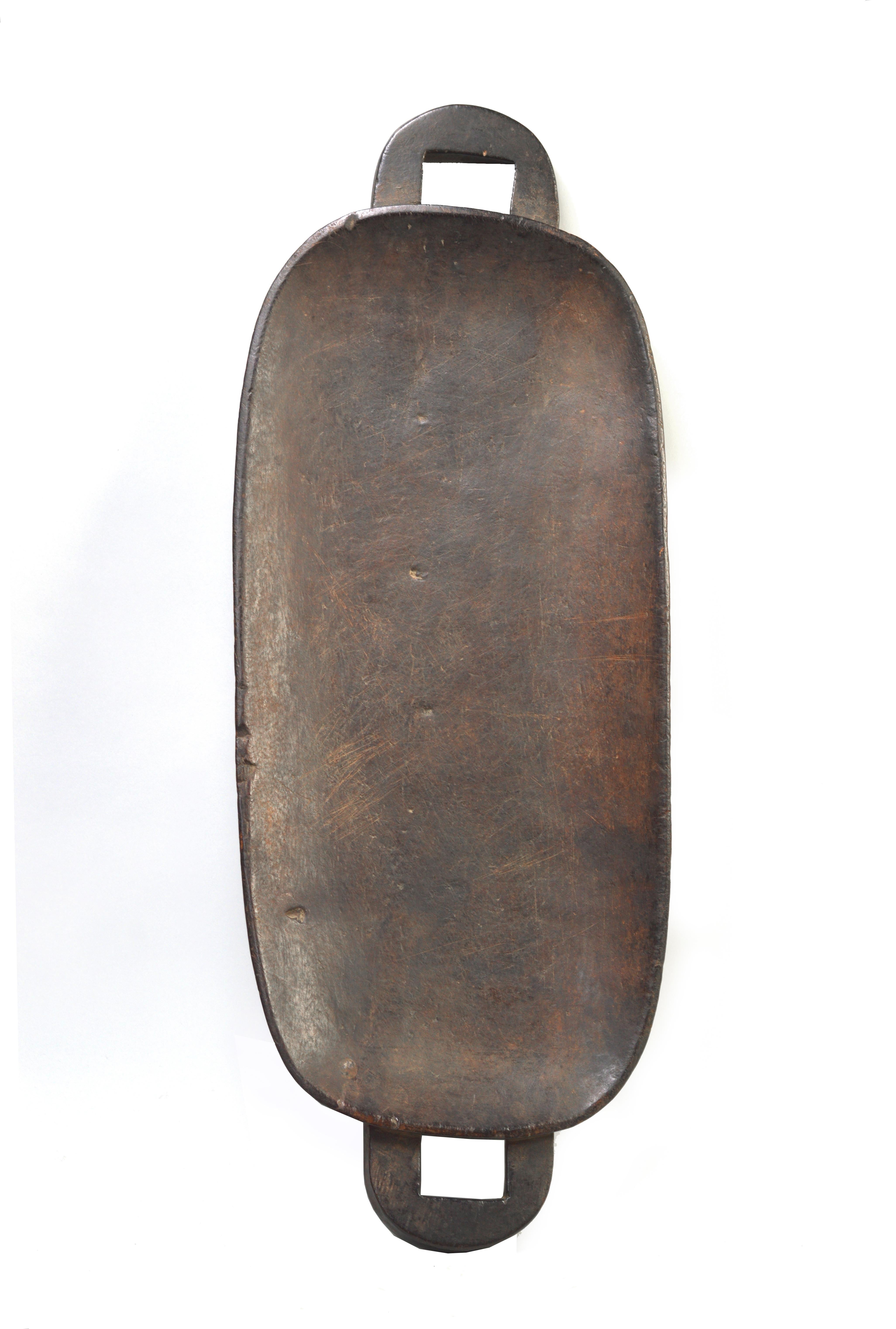 Zulu meat platters, called ugqoko in Zulu, are used at ceremonial gatherings for the carving and serving of meat from ritually-slaughtered livestock. The distinctive double platter form of this ugqoko serves as a mnemonic device that helps