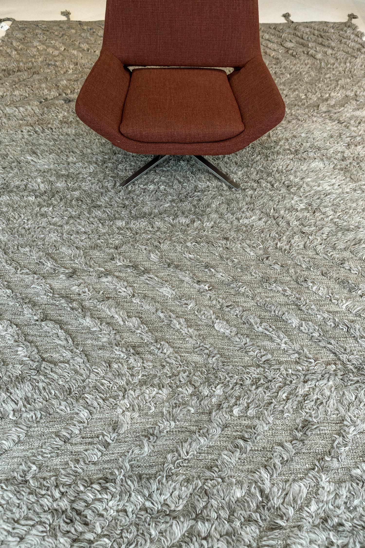 Zuma is a breathtaking rug in our Zigzigzag Collection that features myriads of lines forming zigzag motifs in an artistic manner. Overlaying in a plush gray field, this rug gives a space a charming and inviting feel. Every element of the piece,