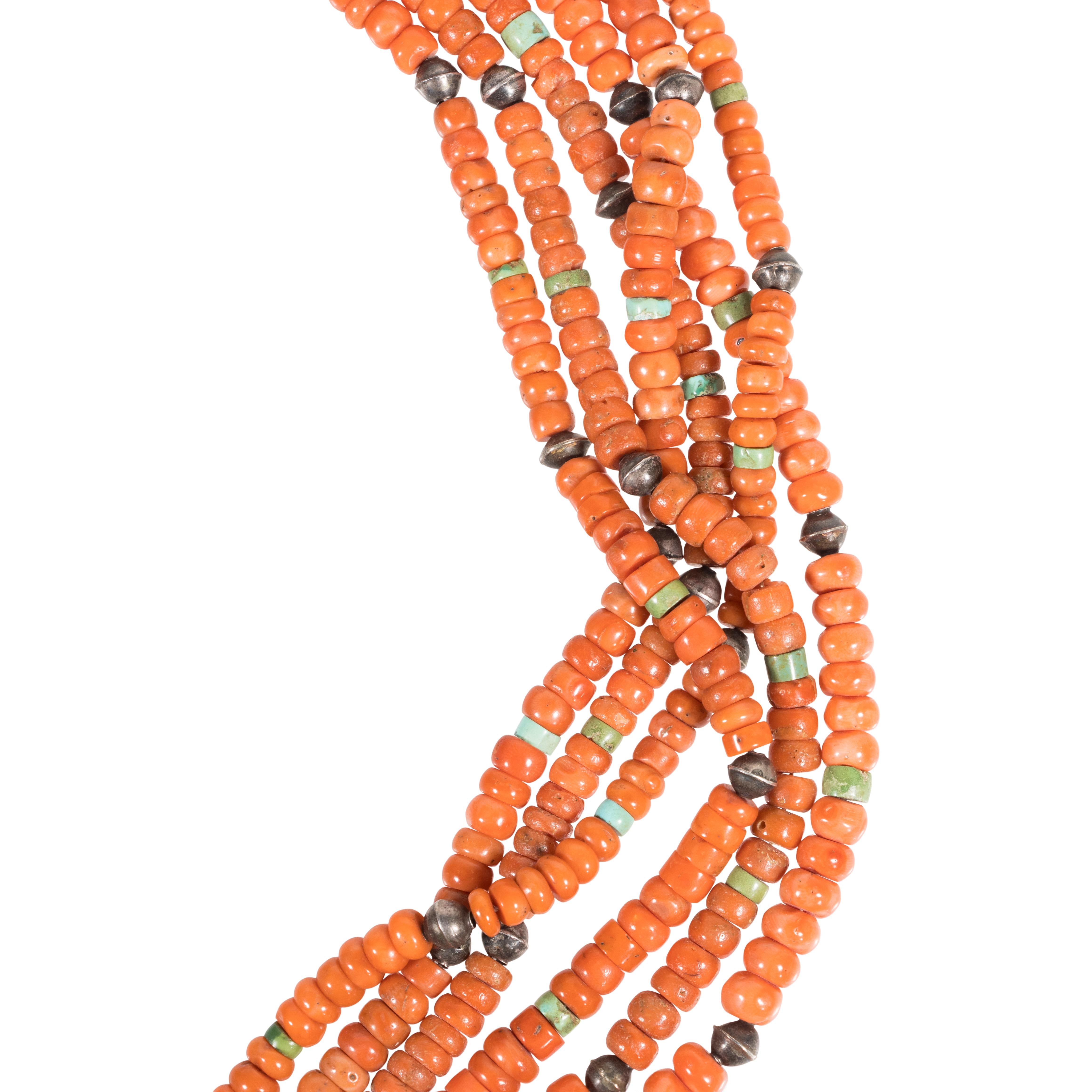 Zuni six strand coral necklace with traditional cord wrapping and strung with graduated coral beads, accented with turquoise and silver beads. Unmarked.

PERIOD: Mid 20th Century

ORIGIN: Southwest - Zuni, Native American

SIZE: 28