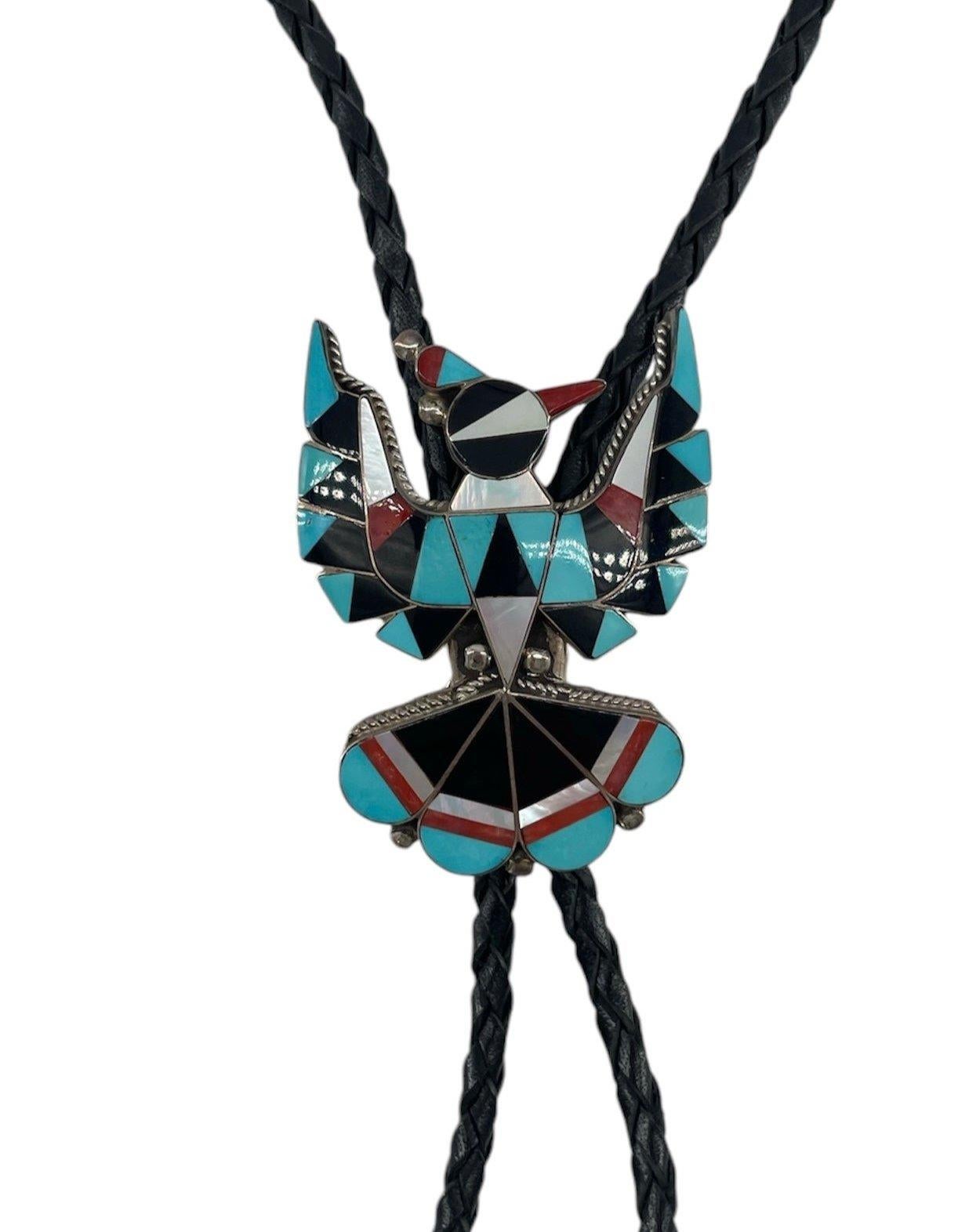 Gorgeous inlaid turquoise, obsidian, coral and abalone with fine detailing. Sterling silver, rope bolo with silver ends. Signed 