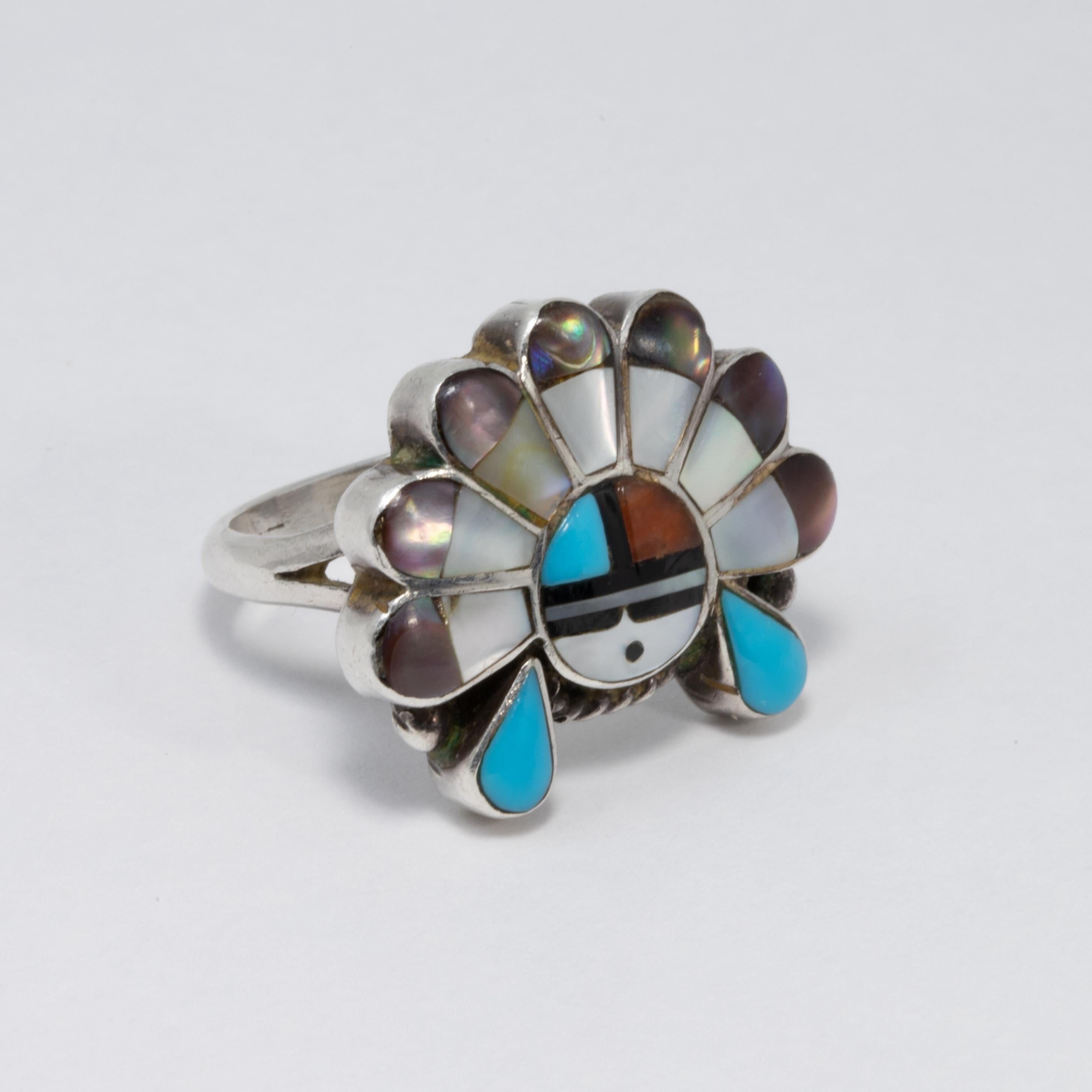 An exquisite Native American Zuni Sun Face ring, decorated with sleeping beauty turquoise, coral, and abalone shell inlays. Set in sterling silver setting and band.

Ring size US 5 - 5.25

Marks / hallmarks / etc: AL