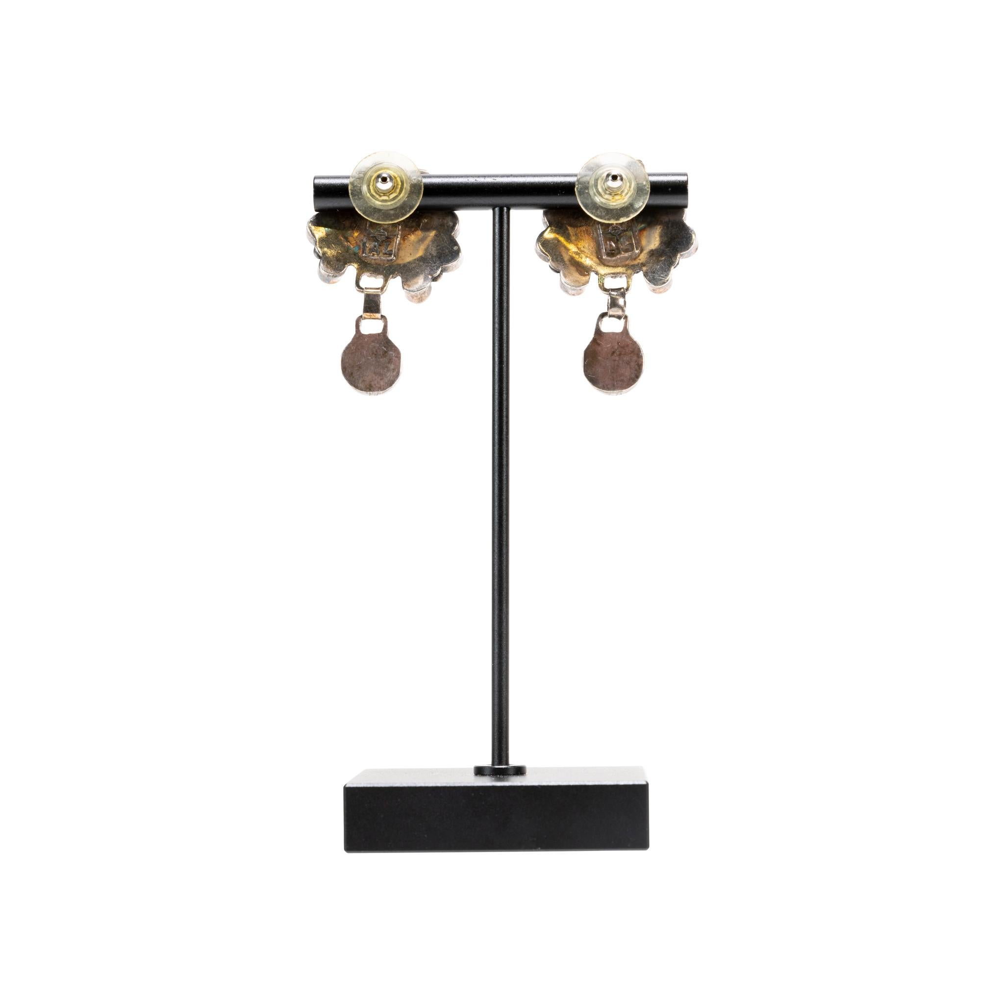 Zuni inlaid squash blossom necklace of mother of pearl, coral, turquoise and onyx set in sterling silver. Ten petals of 