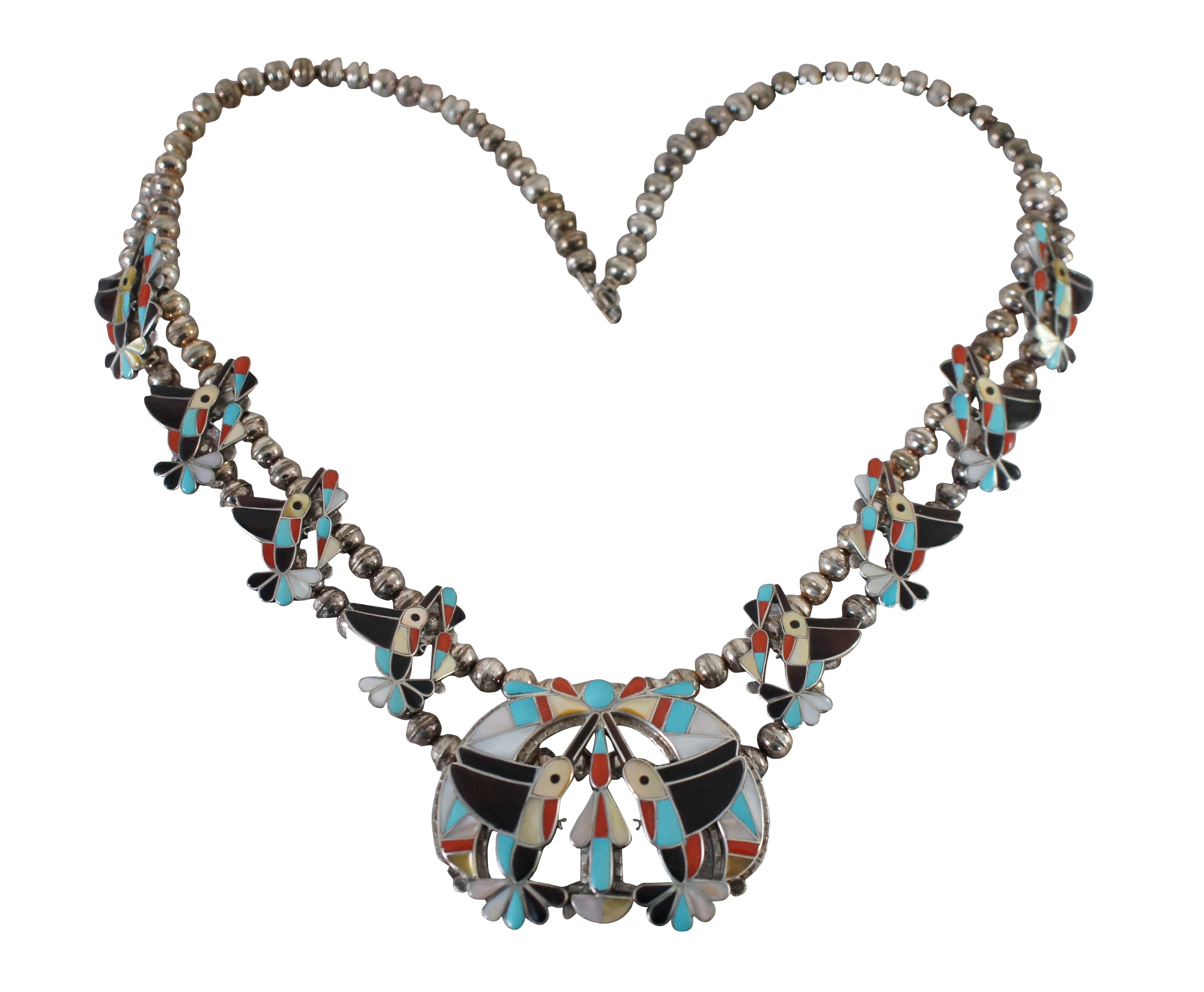 Impressive set of Native American Zuni jewelry featuring a beaded statement necklace, cuff bracelet, ring and earrings.  Each piece features sterling silver with hummingbird / squash blossom theme.  Beautifully inlaid birds with simple flowers and