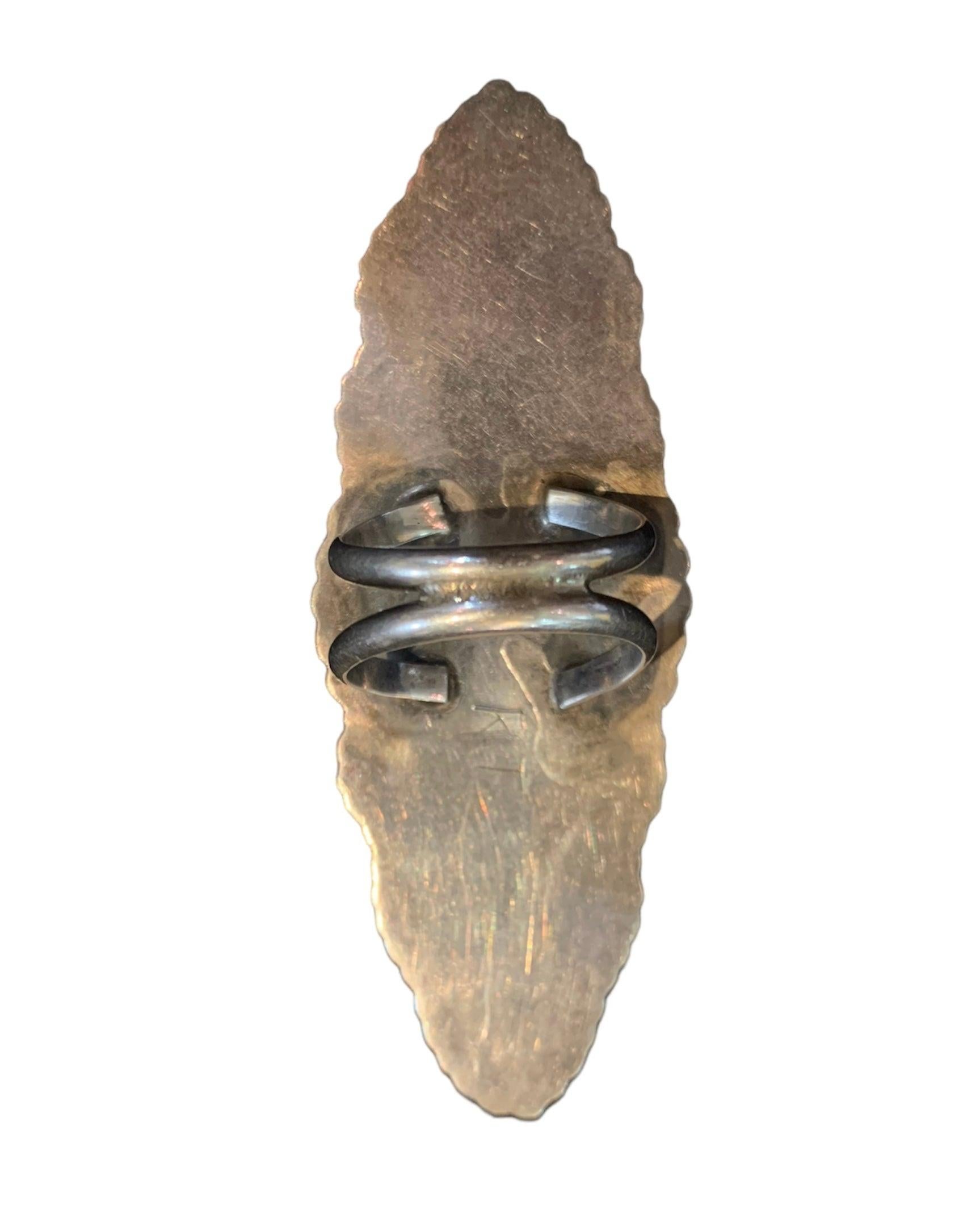 Wear your art on your fingertips with this spectacular vintage Zuni inlay ring. This was hand cast sterling silver. The inlay stones are genuine turquoise, coral, onyx, and mother of pearl. It is signed by the artist Roderick Tenorio of the Zuni