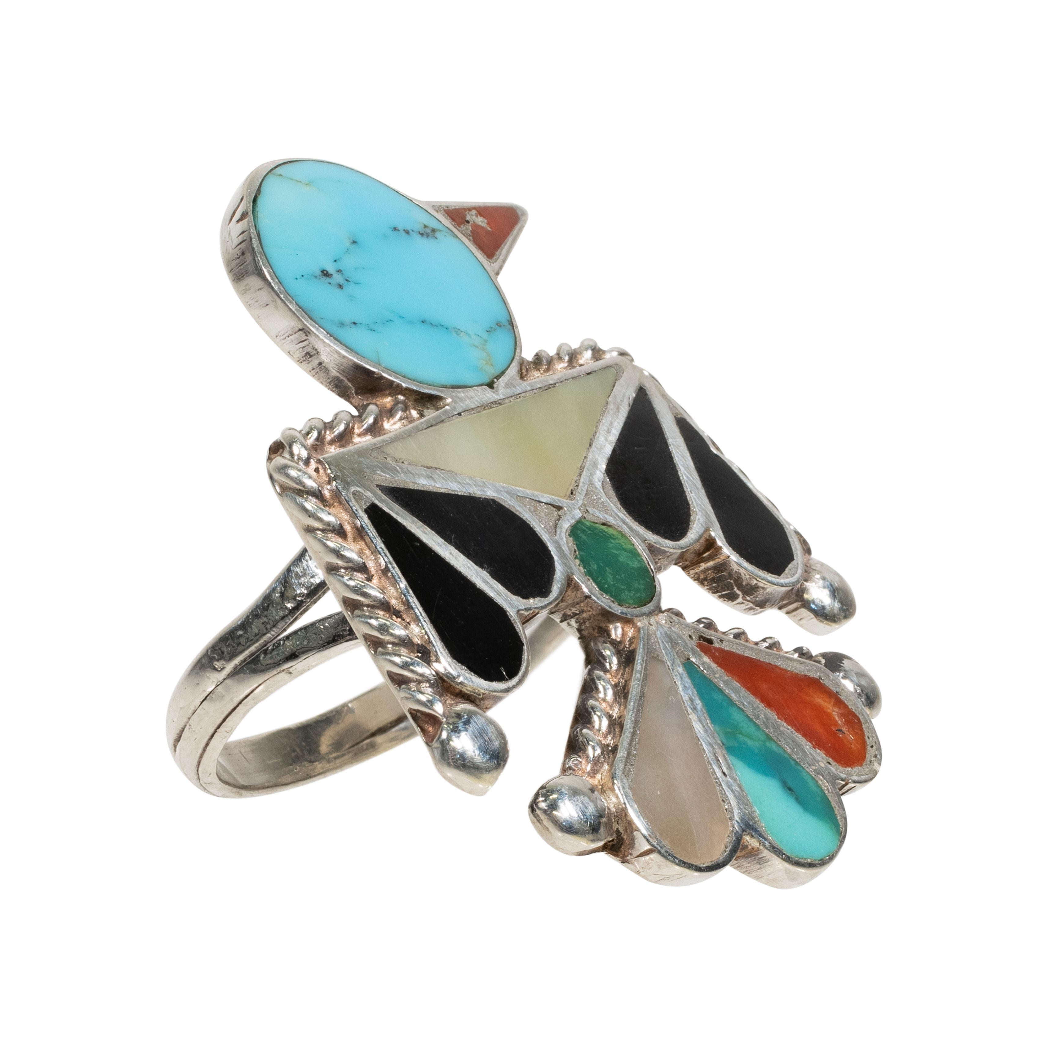 Zuni thunderbird ring with inlaid turquoise, onyx, coral and mother of pearl.

PERIOD: After 1950
ORIGIN: Zuni
SIZE: Size 6.5; 1 1/2