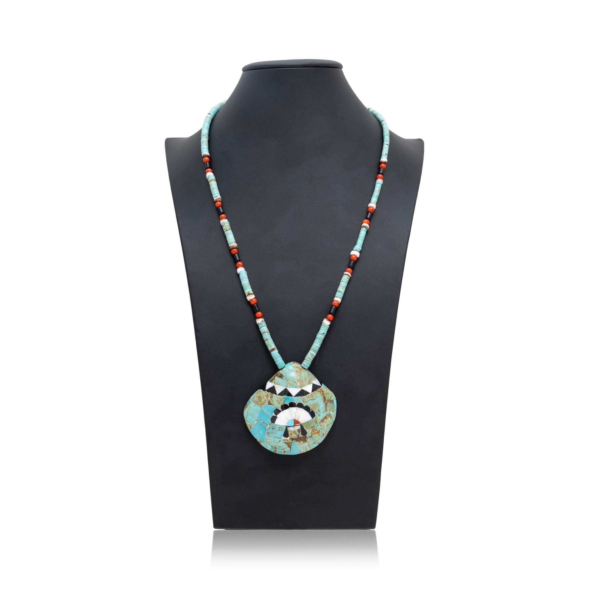 Native American Zuni Indian Kingman turquoise necklace. With beaded chain featuring repeating pattern of Heishi turquoise beads, coral, mother of pearl, and onyx. Chain ends in large shell pendant with inlaid stones of turquoise, onyx, mother of