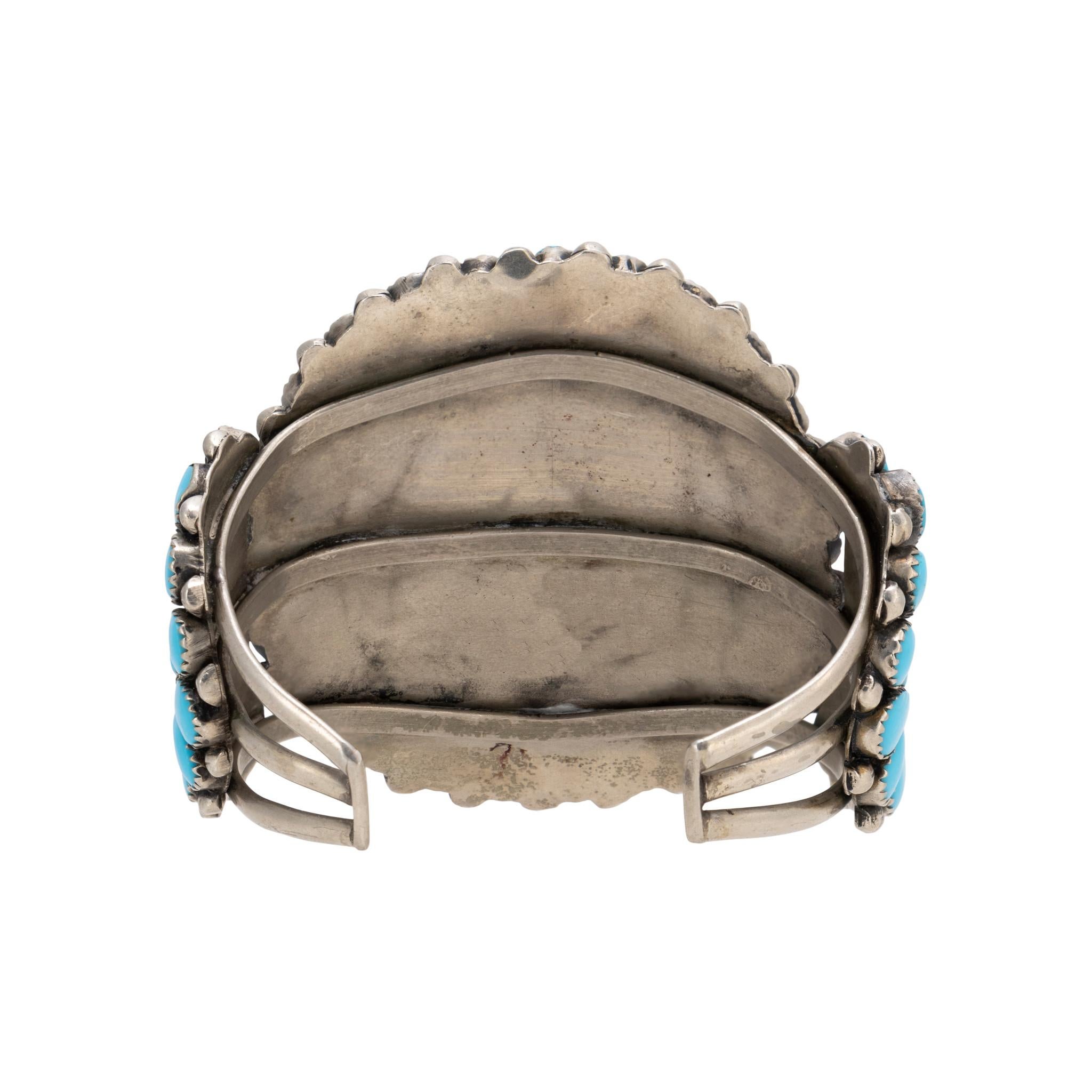 Zuni Sleeping Beauty turquoise and sterling cluster bracelet. Traditional sunburst design with 77 quality, untreated stones. Bright blue color with no matrix. Decorated with twisted rope and sterling bead designs. No maker's mark. Great for casual