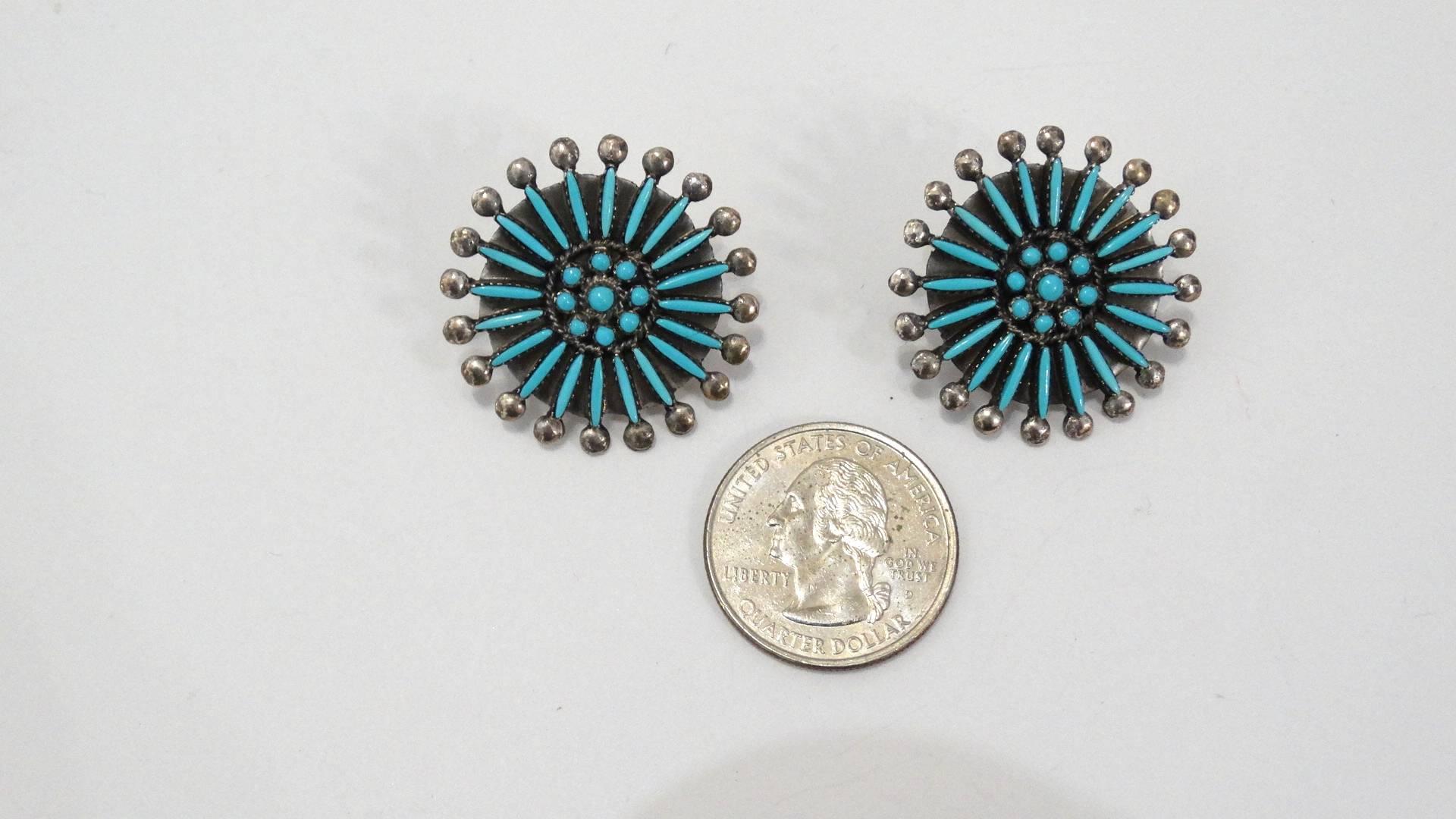 The most AMAZING pair of turquoise earrings, made by the Zuni Native American tribe! Made of a quality sterling silver, inlayed with a medallion of needle point cut turquoise stones, each tipped with a ball of silver. Rock these with your favorite