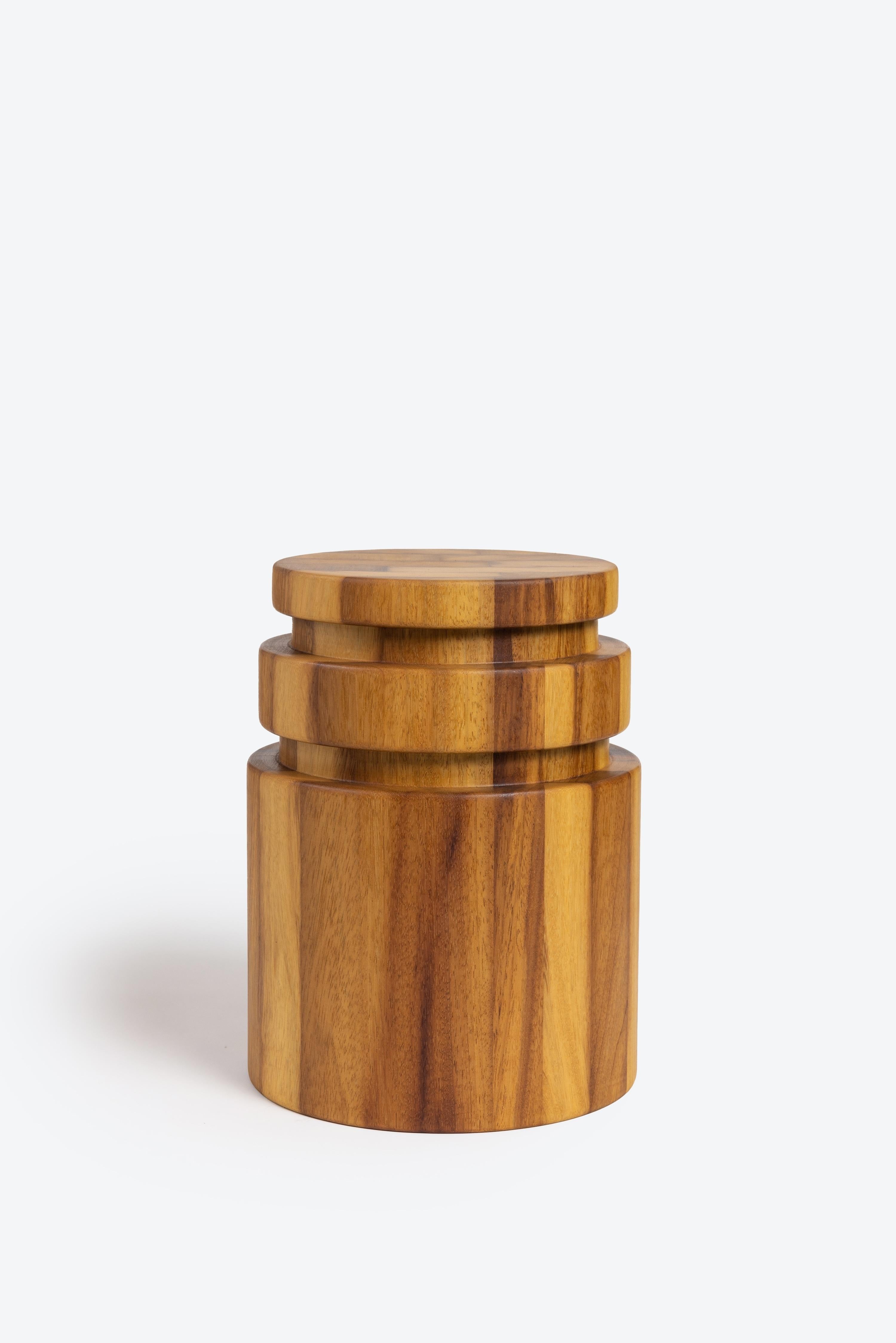 A solid wood stool turned on the lathe with three tiers. It can be used for seating or as a side table. It stands at 16 inches tall x 12 inches in diameter and weighs roughly 30 pounds. Made from Iroko wood. Each stool is unique based on the