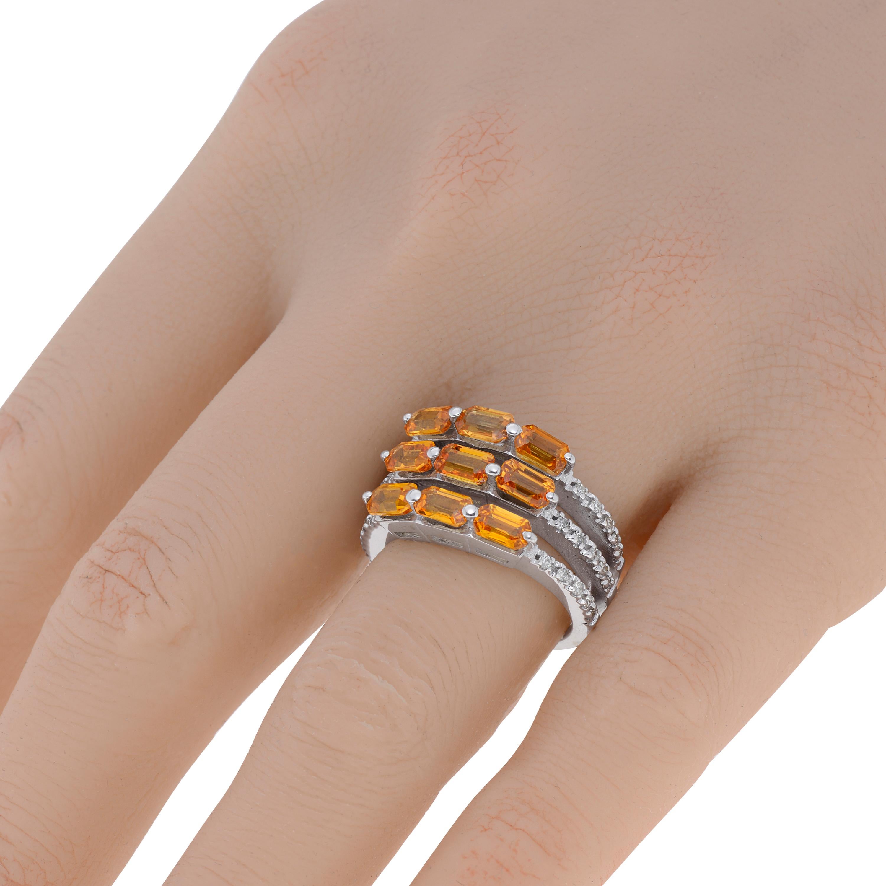 This glittering Zydo 18K white gold ring features 3.54ct. tw. faceted orange sapphires set in a multi band of 0.22ct. tw. diamonds. The ring size is 6.75 (53.8). The decoration size is 5/8