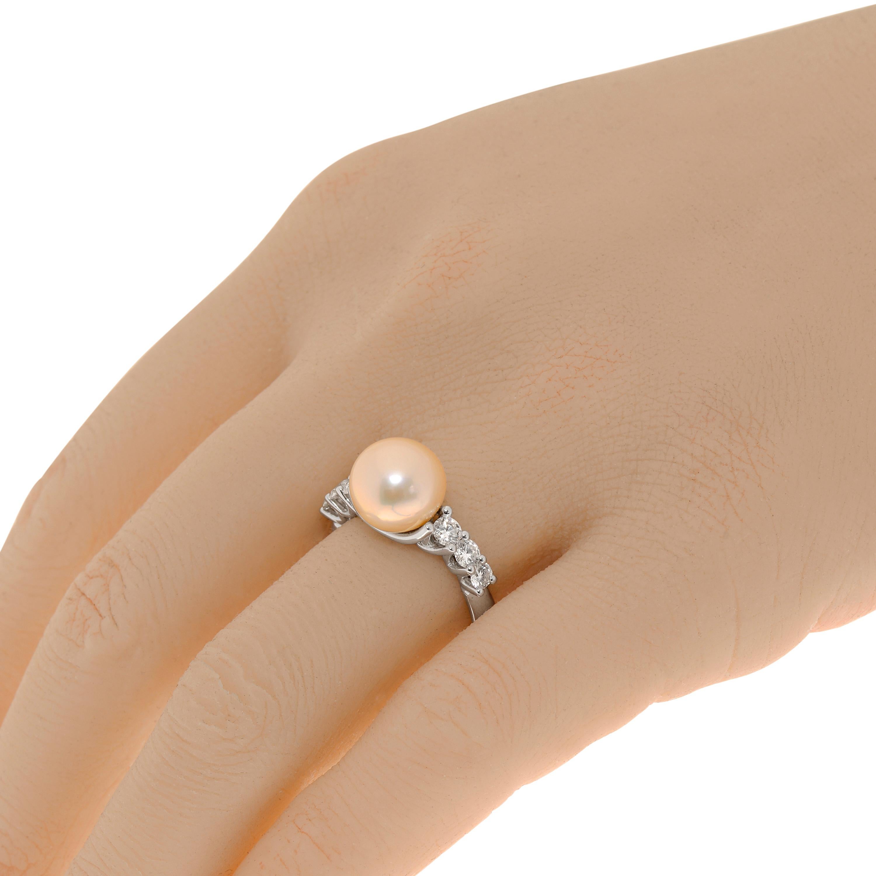 Zydo 18K white gold band ring features 0.57ct. tw. diamonds surrounding a 9.7mm pearl focal point. The ring size is 6.5 (53.1). The decoration size is 9.7mm x 9.7mm. The total weight is 5.6g.

