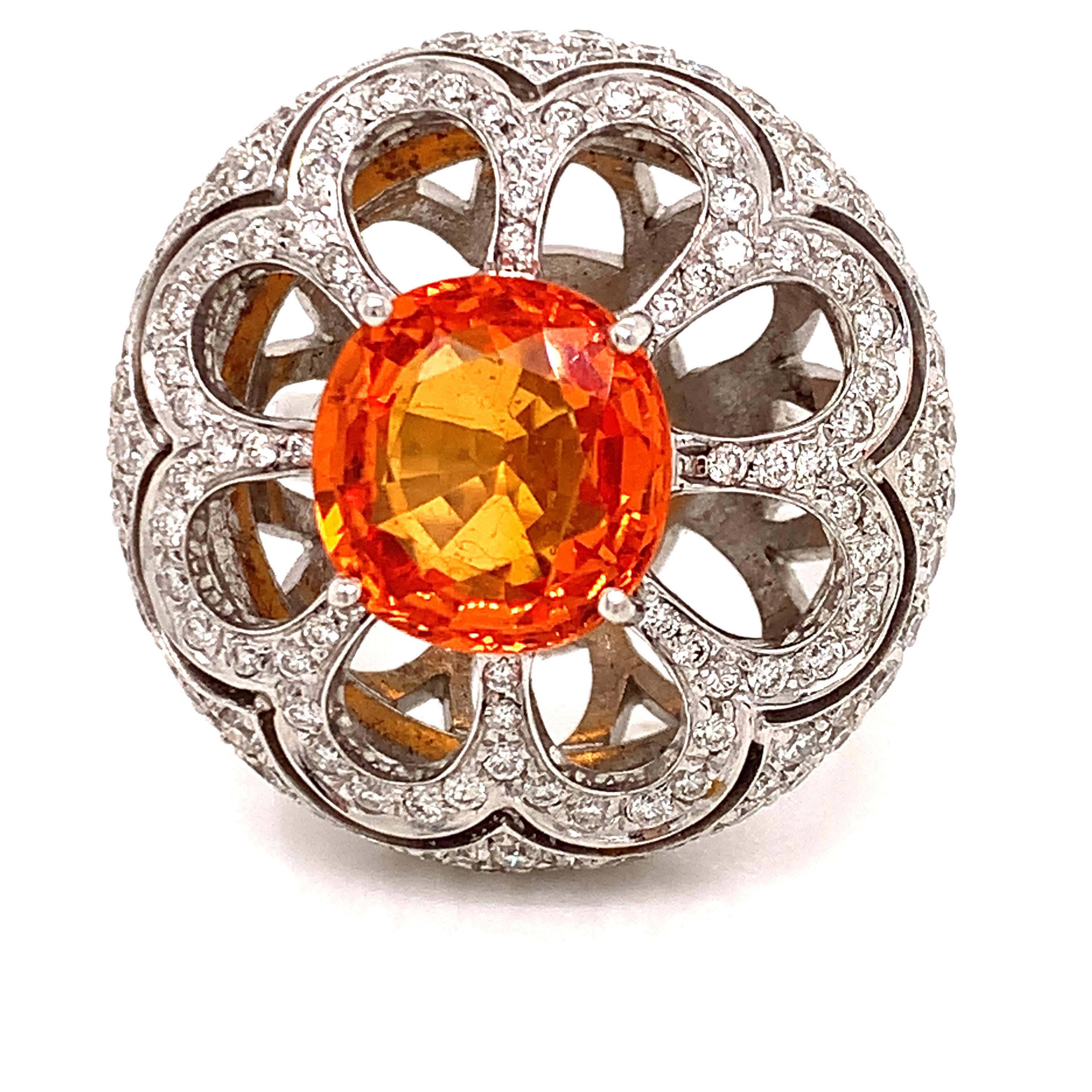 Be the toast of the town in this orange sapphire cocktail ring from iconic Italian brand Zydo.   A stunning statement piece with a 5.10 carat vibrant orange sapphire in the center of 2.45 cttw round diamonds.  This unique ring is a piece of art, set
