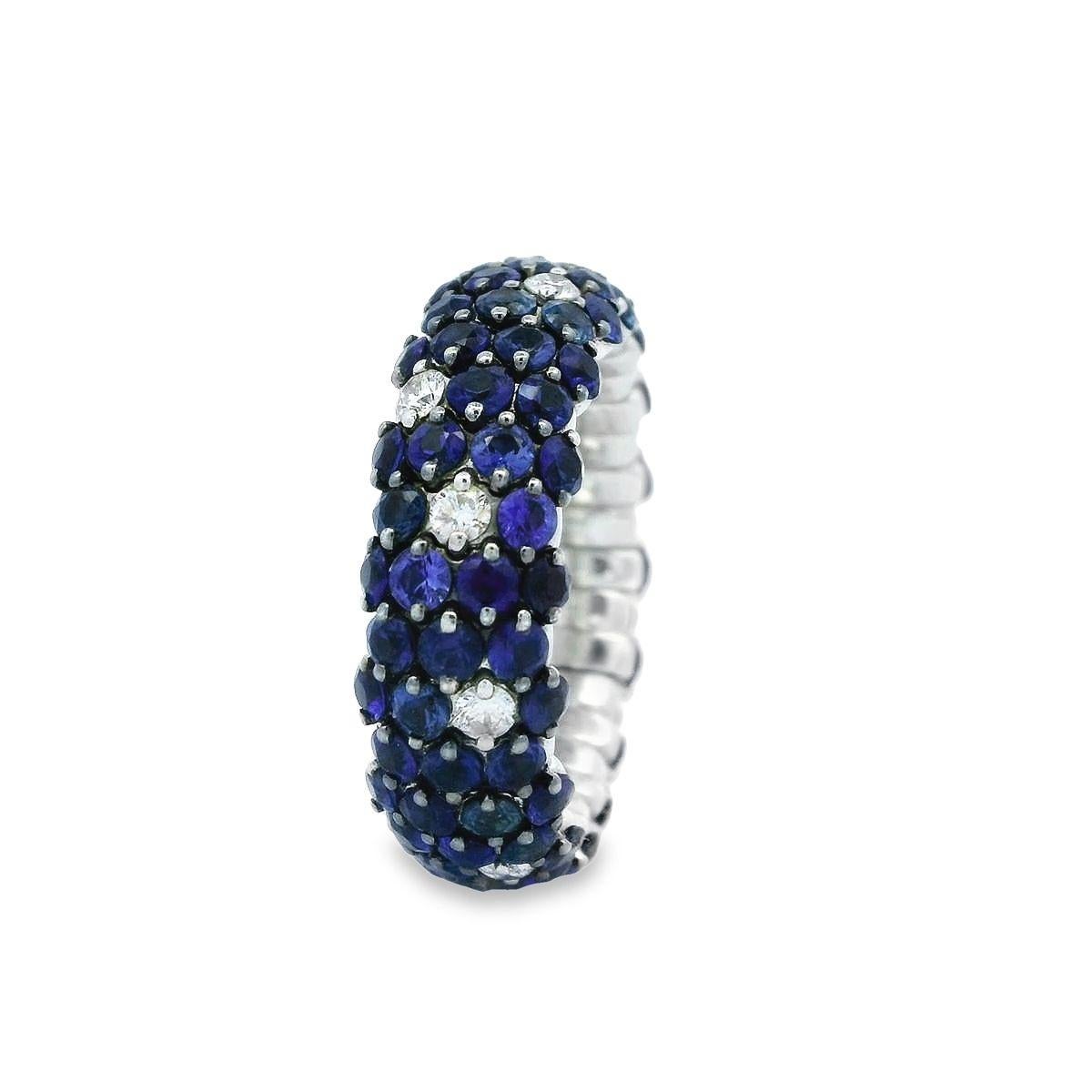Offered by Alex & Co is a striking 18K white gold stretch ring features 4.92ct of round blue sapphires and brilliant cut round diamonds weighing 0.36ct F color, VS clarity classic look. The expanding stretching action makes this ring easy and