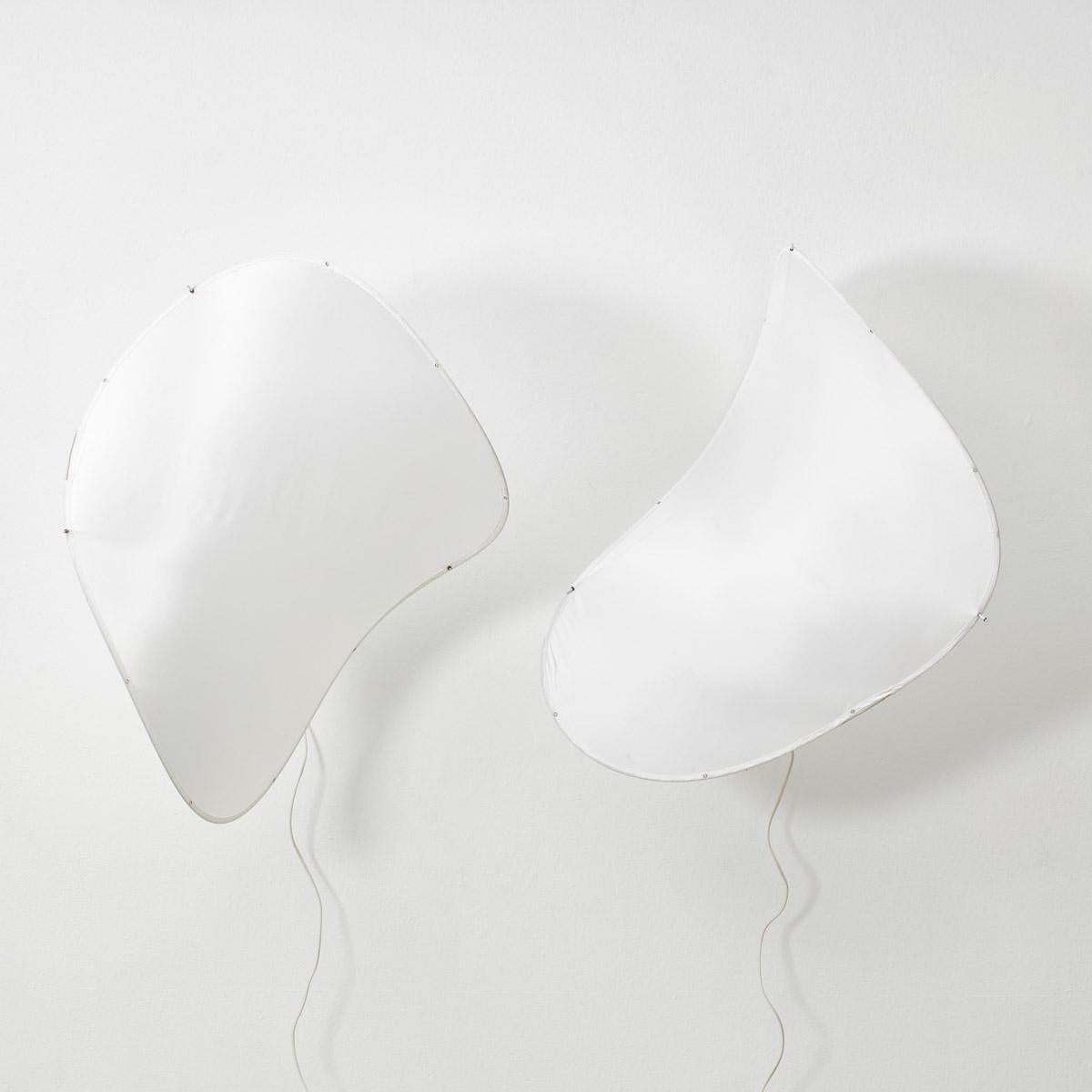 This pair of wall lights by French design studio Zygote have an ethereal and airy feel to them. Pringle shaped sails held aloft by metal and rubber stoppers, the simple mechanism affords the user an opportunity to play and bend the pieces into